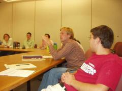 Students actively discuss presenter's research