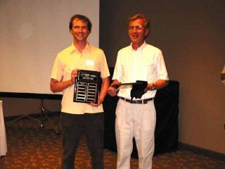 John Morris presents Dr. Peter Cobbett (right) with the first NSP Faculty Award in 2003.