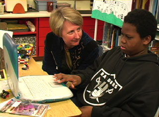 teacher and student at computer