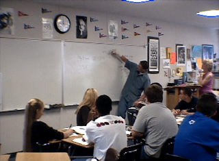student writing on board